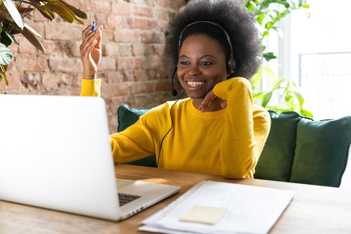 Woman Employee Talking with Clients Online